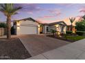 Beautiful desert home featuring low maintenance landscaping and paver driveway in a quiet neighborhood at 883 E Hampton Ln, Gilbert, AZ 85295