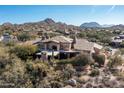 Desert estate aerial view showcasing the covered patio and natural desert landscaping at 10010 E Blue Sky Dr, Scottsdale, AZ 85262