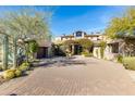 Charming desert home with paver driveway, lush landscaping and an attached garage at 10010 E Blue Sky Dr, Scottsdale, AZ 85262