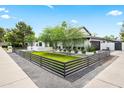 A single story home with neat gravel landscaping, wooden privacy fence, and well-maintained lawn at 101 E Linger Ln, Phoenix, AZ 85020
