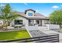 Charming single-story home boasting a manicured front lawn and sleek, minimalist architectural features at 101 E Linger Ln, Phoenix, AZ 85020