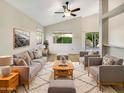 Bright living room featuring vaulted ceilings, neutral paint, stylish furniture, and natural light at 10242 N 66Th Ave, Glendale, AZ 85302