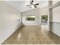 Spacious living room with vaulted ceilings and tile flooring with outdoor views from the windows at 10242 N 66Th Ave, Glendale, AZ 85302