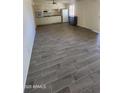 Open-concept living room featuring stylish wood-look tile flooring at 10582 W Oakmont Dr, Sun City, AZ 85351