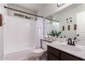 Cozy bathroom with tub, shower, and vanity with white countertop and dark wood cabinets at 19414 N 3Rd Ave, Phoenix, AZ 85027