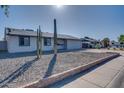 Quaint home with desert landscaping, complete with a large Saguaro cactus and low-maintenance rock ground cover at 19849 N 33Rd Ave, Phoenix, AZ 85027