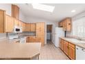 Functional kitchen with light wood cabinetry, ample counter space, and white appliances at 201 S Greenfiled Rd -- # 199, Mesa, AZ 85206