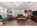 Inviting living room with wood-look floors, neutral colors, and cozy seating at 201 S Greenfiled Rd -- # 199, Mesa, AZ 85206