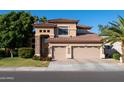 Inviting two-story home featuring a two-car garage, manicured lawn, and desert landscaping at 2224 W Olive Way, Chandler, AZ 85248