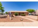 Charming single-story home featuring desert landscaping, a brick walkway, and an attached garage at 2302 E Monte Cristo Ave, Phoenix, AZ 85022