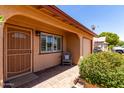 Home exterior with brick entry and shade plants and view of the garage at 2302 E Monte Cristo Ave, Phoenix, AZ 85022