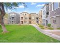 Attractive condominium exterior with a beautiful grassy area and manicured landscaping at 2401 E Rio Salado Pkwy # 1055, Tempe, AZ 85288