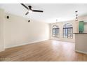 A spacious living room with wood floors, modern ceiling fan, and large arched windows at 2401 E Rio Salado Pkwy # 1055, Tempe, AZ 85288