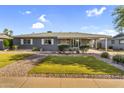 Charming single-story home with xeriscaped front yard and covered parking at 2715 E Edgemont Ave, Phoenix, AZ 85008
