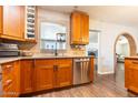 Well-appointed kitchen with wooden cabinetry, granite countertops, and stainless steel appliances at 2715 E Edgemont Ave, Phoenix, AZ 85008