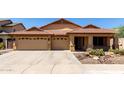 Charming single-story home with a three-car garage, desert landscaping, and a tile roof at 3028 W Parkside Ln, Phoenix, AZ 85027