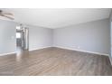 Spacious living room featuring hardwood floors and neutral-colored walls at 3230 E Pinchot Ave # 32, Phoenix, AZ 85018