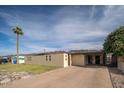 Exterior angle shot of a house featuring low-water landscaping and a long driveway at 327 E Monte Way, Phoenix, AZ 85042