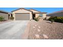 Inviting single-Gathering home with desert landscaping, a spacious driveway, and a welcoming covered entrance, under a clear blue sky at 36515 N Takota Trl, San Tan Valley, AZ 85140