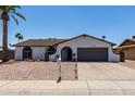 Single-story home with a well-maintained front yard, mailbox, and a two-car garage at 3765 W Wood Dr, Phoenix, AZ 85029