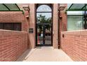 Stadium Lofts entrance featuring a brick facade, stylish glass doors, and exterior lighting at 424 S 2Nd St # 306, Phoenix, AZ 85004