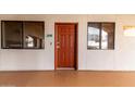 Condo entrance featuring a vibrant red door, unit number 306, and adjacent windows for natural light at 424 S 2Nd St # 306, Phoenix, AZ 85004