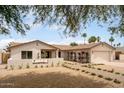 Attractive single-story home with desert landscaping, brick walkway, built-in seating and a two-car garage at 4948 E Evans Dr, Scottsdale, AZ 85254