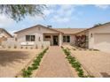 Inviting home with a cozy front entryway, lush bougainvillea, desert landscaping, and a covered entry at 4948 E Evans Dr, Scottsdale, AZ 85254