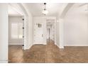 Inviting foyer with tiled floors, high ceilings, arched doorways, and natural light at 5446 S Sandstone Ct, Gilbert, AZ 85298