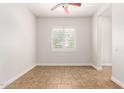 Empty room with tile floor, neutral paint, and a bright window at 5446 S Sandstone Ct, Gilbert, AZ 85298