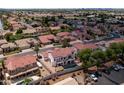An aerial view showcases a residential area with a swimming pool and easy access to a nearby lake at 579 N Mondel Dr, Gilbert, AZ 85233