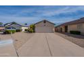Traditional one-story home with low maintenance desert landscaping and an attached two-car garage at 5924 W Shangri La Rd, Glendale, AZ 85304