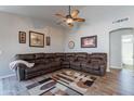 Comfortable living room featuring a plush sectional sofa, ceiling fan and a decorative rug at 5924 W Shangri La Rd, Glendale, AZ 85304
