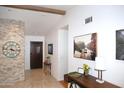 Inviting entryway features a stone accent wall, tile flooring, and striking interior decor at 6920 E Beverly Ln, Scottsdale, AZ 85254
