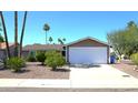 Inviting single-story home with a neatly landscaped front yard and a two-car garage at 6920 E Beverly Ln, Scottsdale, AZ 85254