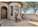 Inviting front patio area with two chairs and an orange table, perfect for enjoying the outdoor ambiance at 7221 E Eclipse Dr, Scottsdale, AZ 85266