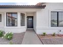 This image showcases the front entrance with its black front door and well-maintained landscaping at 743 N Bermuda --, Mesa, AZ 85205