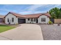 Single-story home featuring a neutral exterior paint, a well-manicured lawn, and a concrete driveway at 743 N Bermuda --, Mesa, AZ 85205