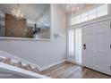 Bright entryway with hardwood floors, a stylish chandelier, and a staircase leading to the upper level at 7800 E Lincoln Dr # 2029, Scottsdale, AZ 85250