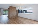 Spacious living room featuring hardwood floors and a view into a kitchen with modern appliances at 7800 E Lincoln Dr # 2029, Scottsdale, AZ 85250
