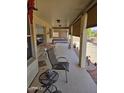 Relaxing outdoor patio area featuring a comfortable chair, side table and a view of the backyard at 8303 E Meseto Ave, Mesa, AZ 85209