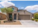Charming two-story home featuring a well-manicured lawn, tree, and an attached two-car garage at 8924 N 102Nd Ln, Peoria, AZ 85345
