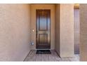 A covered front porch with a decorative wooden door and a 