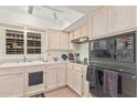 Well lit kitchen with white cabinets, neutral countertops, and modern appliances at 10626 N 8Th St, Phoenix, AZ 85020