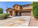 Charming two-story home boasting a spacious driveway and attached two-car garage at 12128 W Range Mule Dr, Peoria, AZ 85383