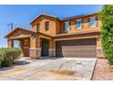 Inviting home featuring a spacious two-car garage and well-kept front yard at 12128 W Range Mule Dr, Peoria, AZ 85383