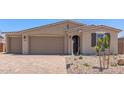 Attractive single-story home with a three-car garage, complemented by tidy landscaping and a quaint arched entryway at 12389 W Marguerite Ave, Avondale, AZ 85323