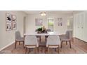 Elegant dining room showcasing a marble-topped table with seating for six and stylish decor at 1245 W Lobo Ave, Mesa, AZ 85202