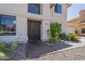 Inviting home featuring a secure gate, desert landscaping, and a bright exterior at 1320 N Brittany Ln, Gilbert, AZ 85233