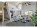 Bright living room featuring vaulted ceilings, large windows, and a staircase at 1320 N Brittany Ln, Gilbert, AZ 85233